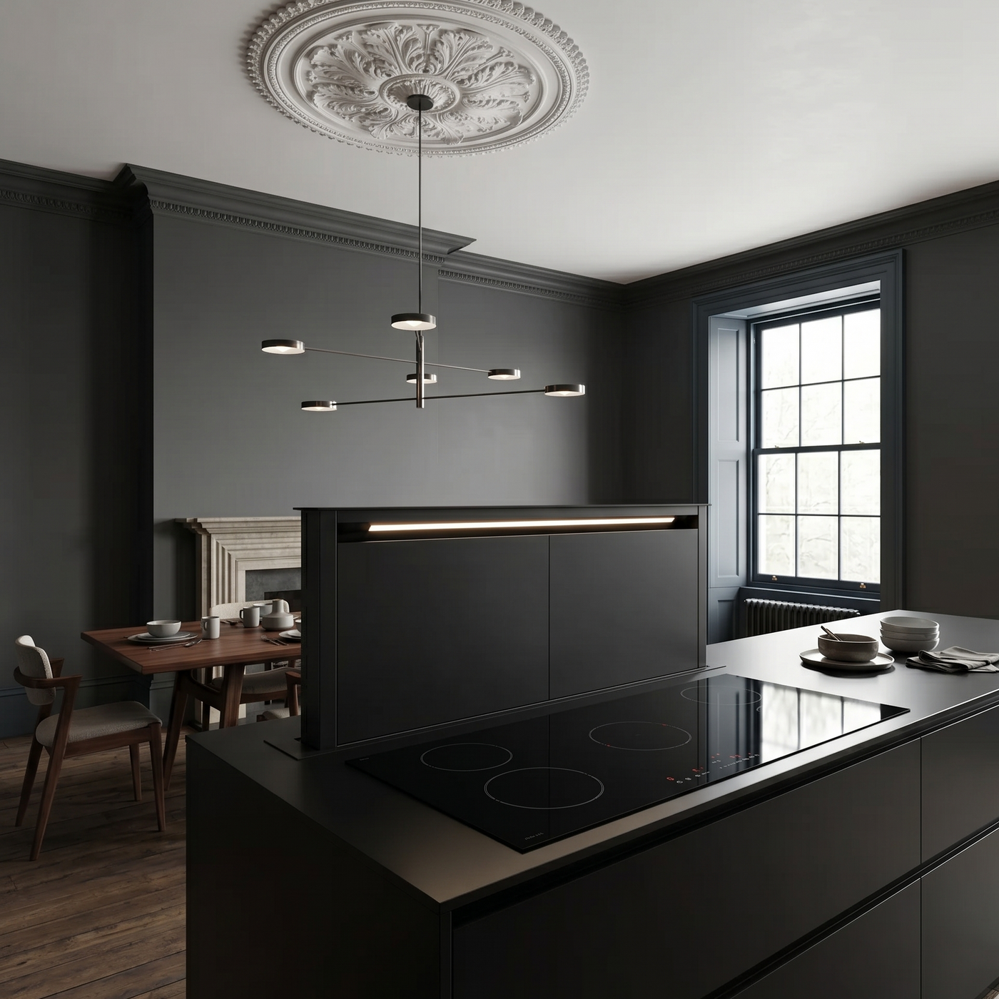Luxair 180cm matte black downdraft extractor hood integrated into a modern kitchen island with an induction hob. pop-up downdraft cooker hood and period architecture details.
