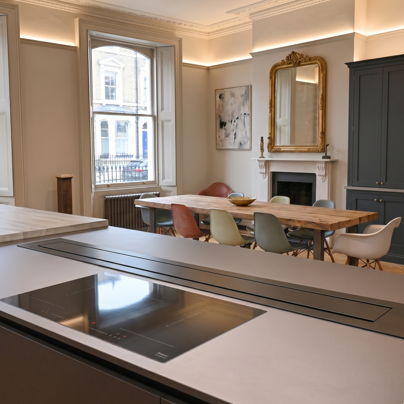 200cm Luxair Gourmet Station downdraft cooker hood, fully retracted and flush-mounted into a modern grey kitchen island behind a black induction hob.