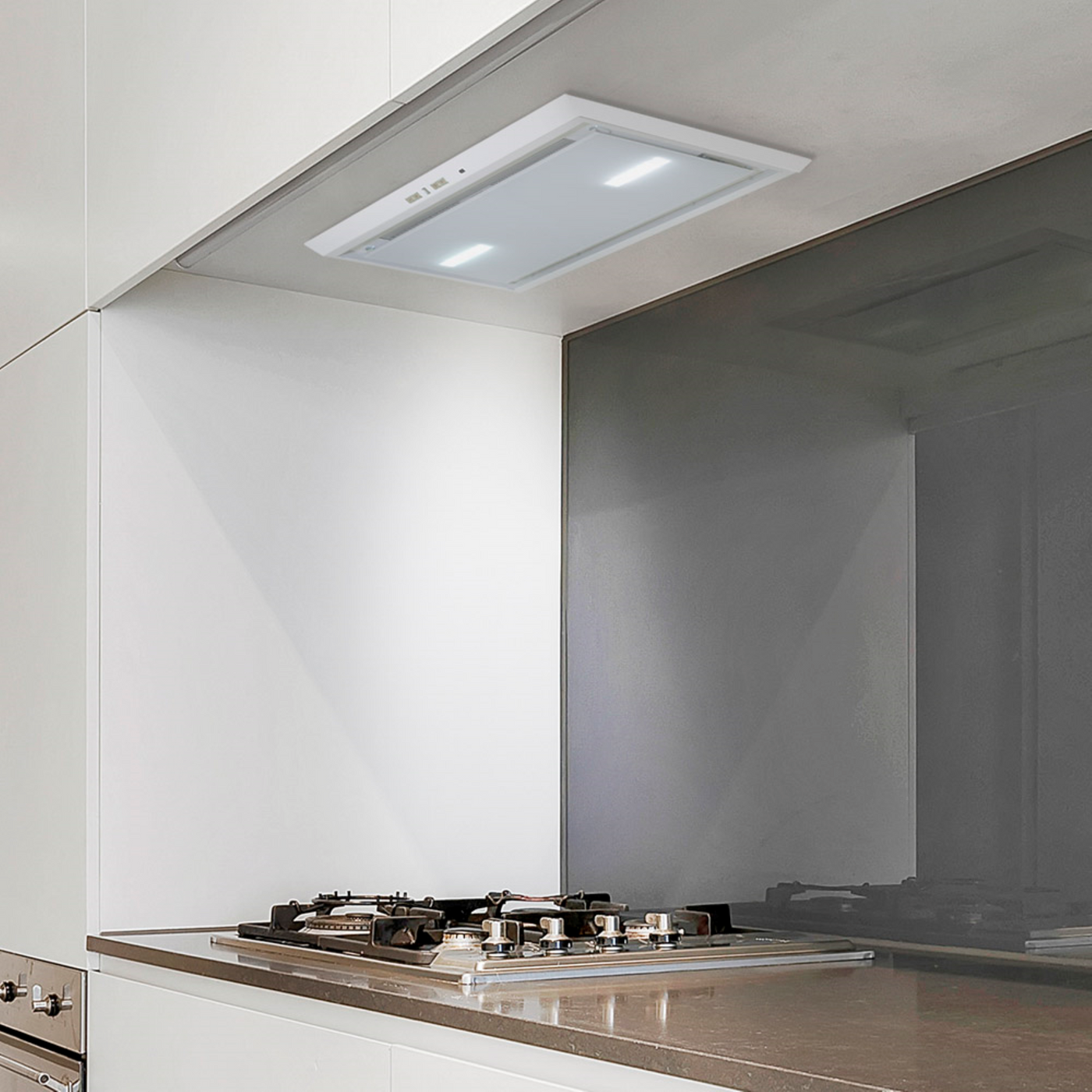 Luxair 54cm white glass canopy cooker hood with LED lights, integrated into white minimalist kitchen cabinetry above a gas hob.