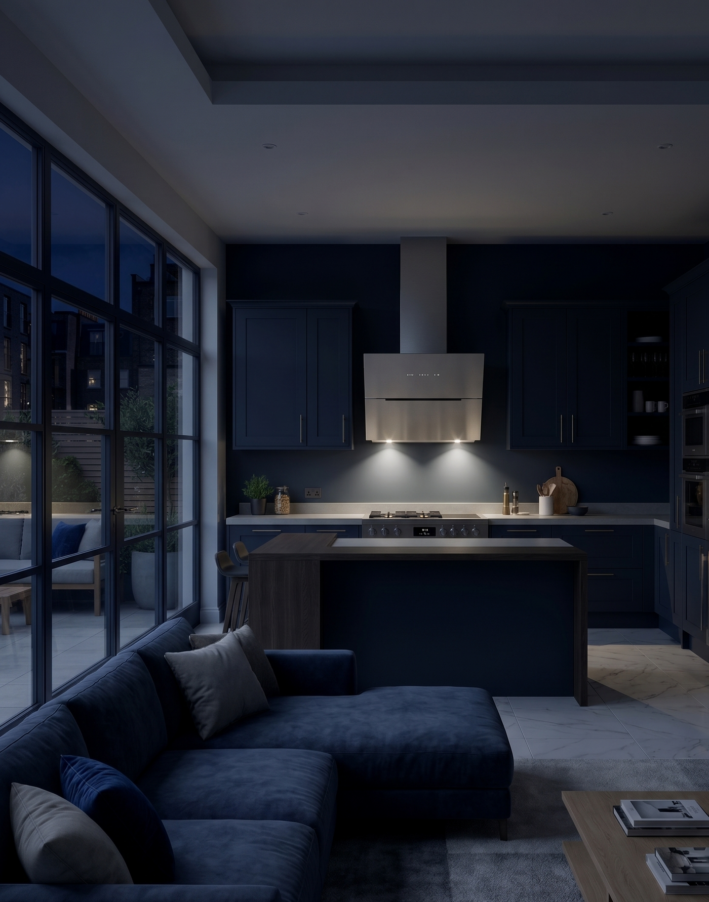 90cm Ascenti angled stainless steel cooker hood installed in an open plan kitchen living area featuring dark navy blue units and sofa