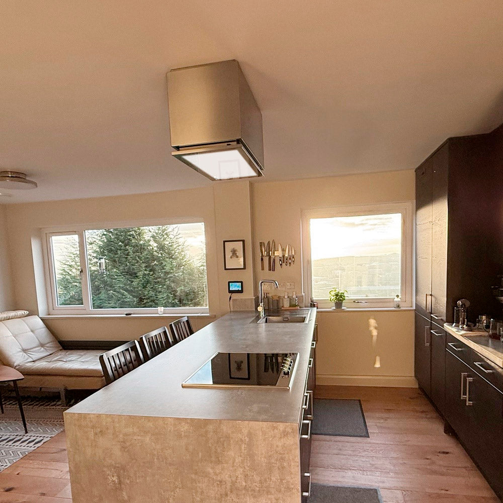 Tolvi Lusso With Stainless Steel Ceiling Mount Box Installed Modern kitchen with island and seating area in a home setting