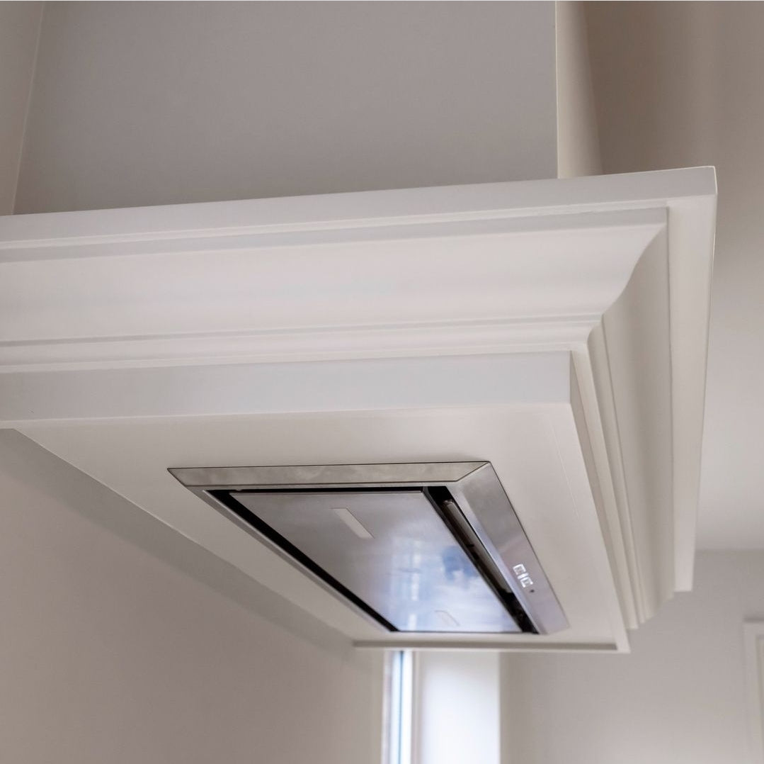 Luxair 86cm stainless steel canopy cooker hood integrated into a white decorative chimney breast with crown molding details.