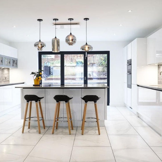 Luxair 800mm white slimline ceiling cooker hood installed over a modern kitchen island with white gloss cabinets and glass pendant lights.