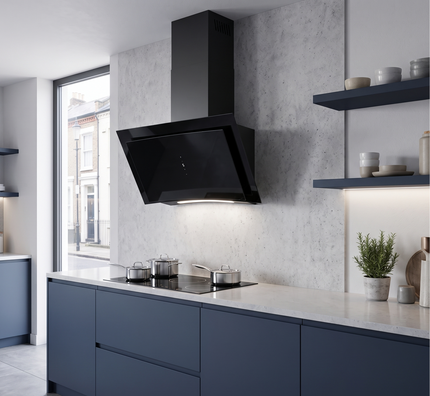 90cm Curva wall mounted cooker hood, with sleek curved glass design. Installed within a navy blue and grey kitchen featuring a marble countertop.