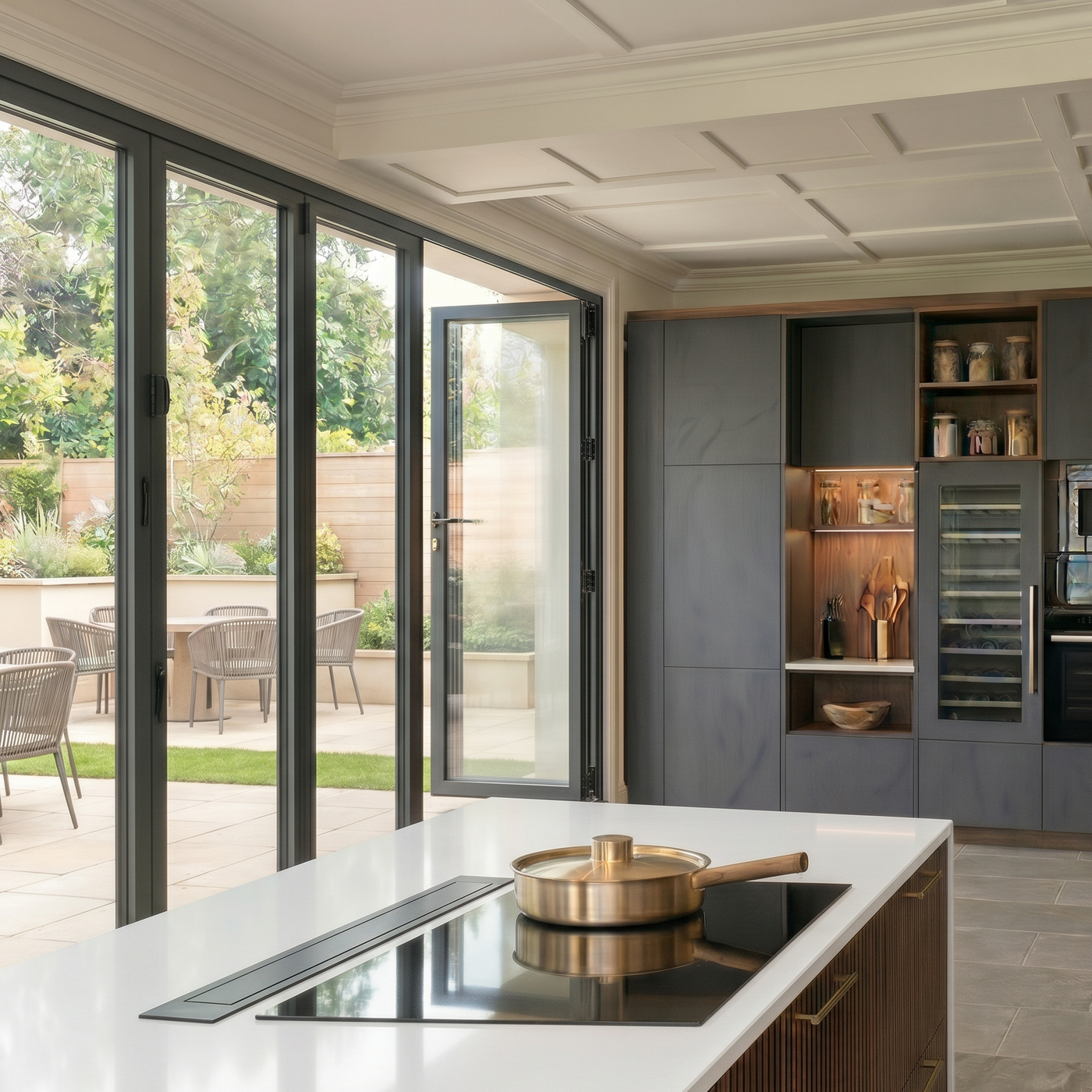 Modern luxury kitchen island with integrated induction hob and the Lxuair 90cm retracted black downdraft extractor, featuring white quartz worktops, dark fluted wood cabinetry.