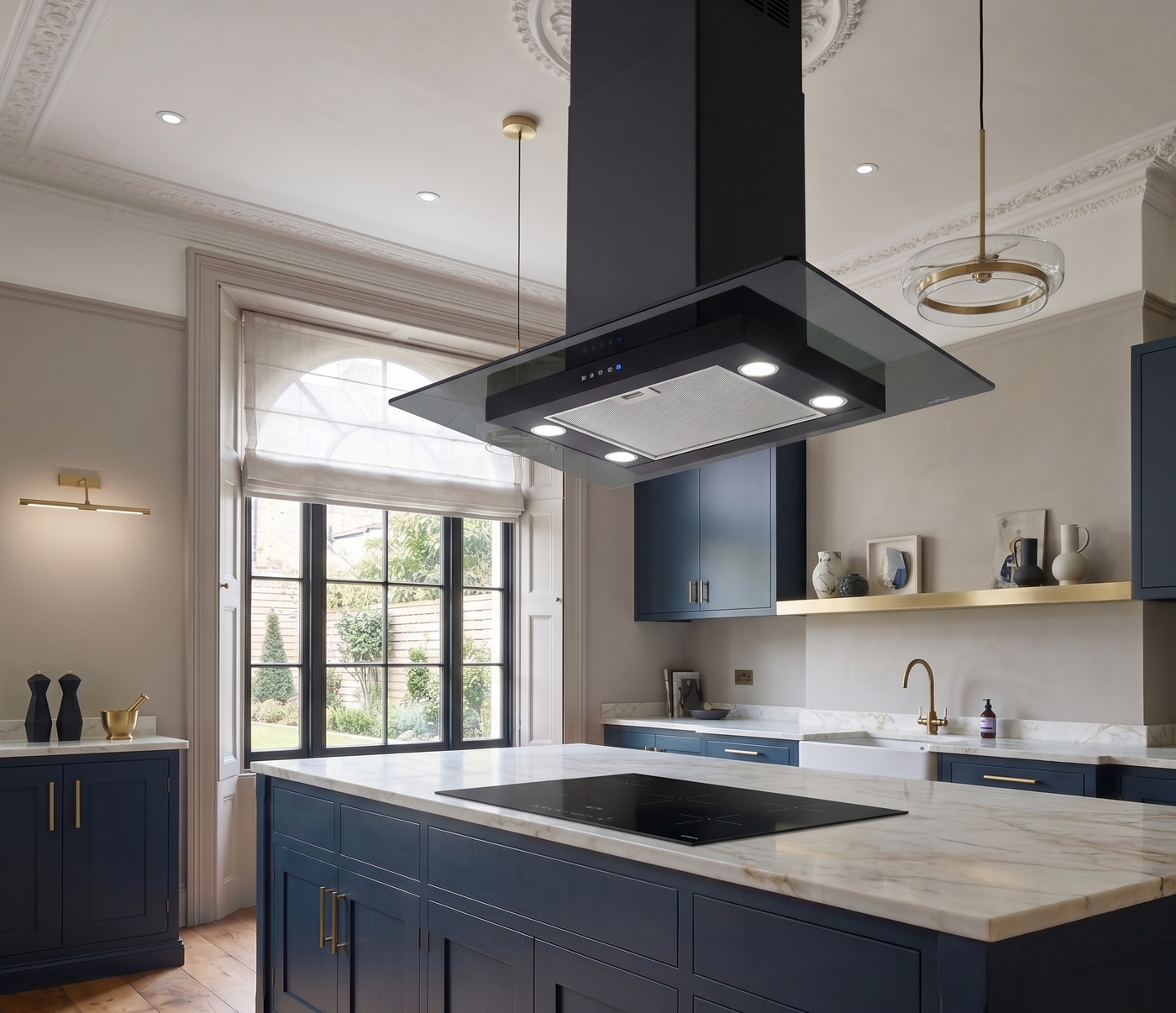 Straight glass island cooker hood in black, installed within a modern shaker style navy blue kitchen with marble countertop