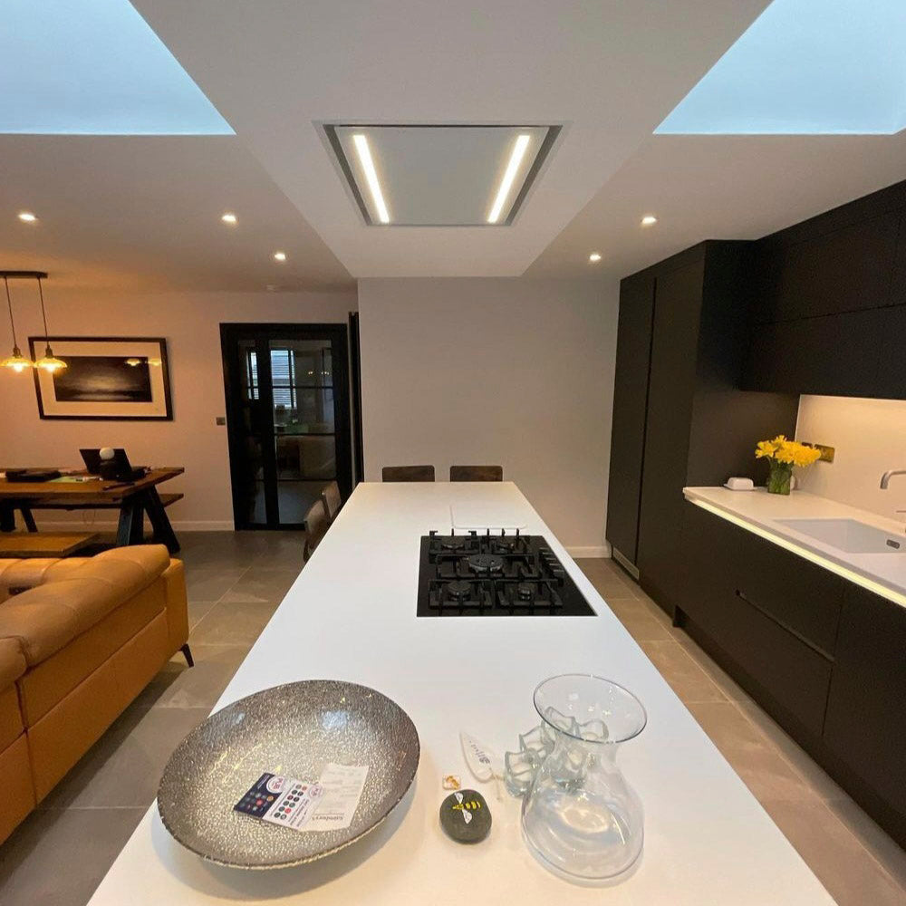 Modern Kitchen With a White Island Featuring a Gas Hob and 90cm Celux Cooker Hood In White, Surrounded By a Living Area.