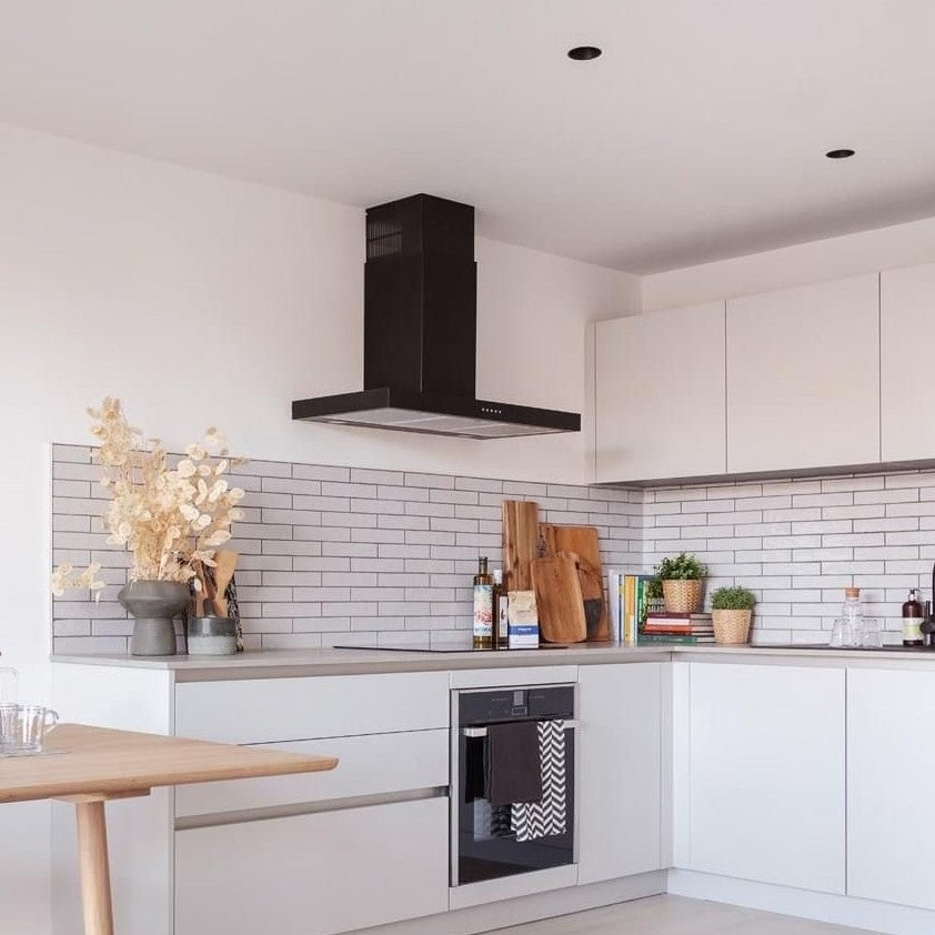 90cm black FLT wall mounted extractor within a modern kitchen with built in appliances and tiled backsplash