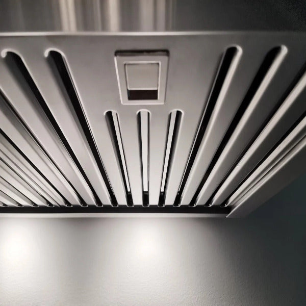 Close-up of a stainless steel range hood with a grid design.