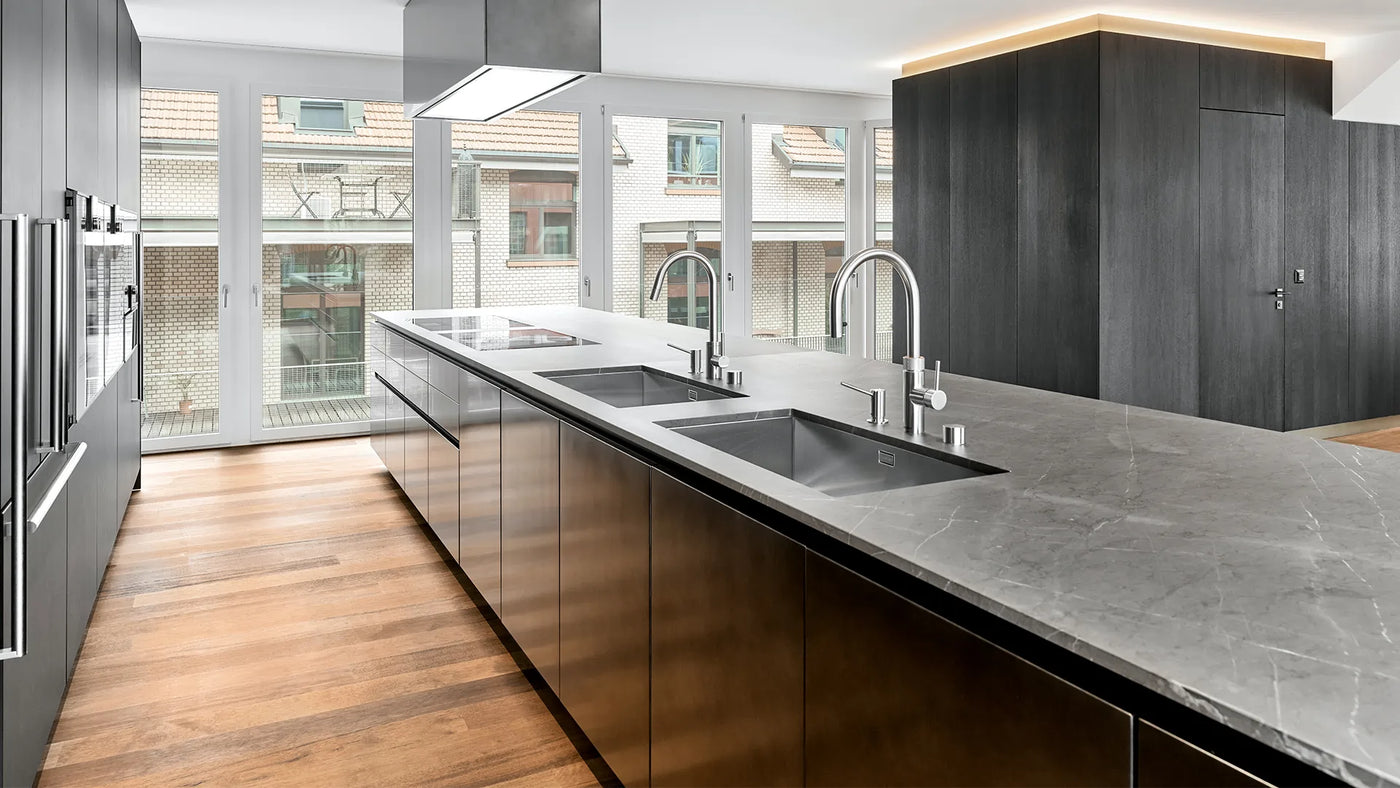 120cm Tolvi Cooker Hood In a Modern Kitchen With Grey Marble Countertops And Wooden Flooring