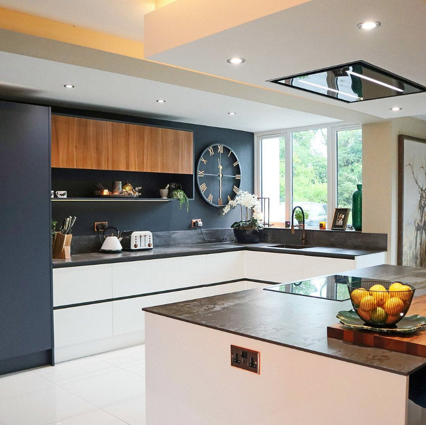 90cm Celux Cooker Hood In Black Installed Within A Modern Black and White Kitchen with Wooden Features and Black Marble Countertop. 