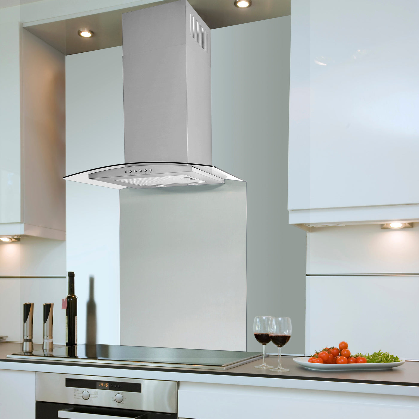 Artis curved cooker hood installed within a sleek kitchen featuring stainless steel splashback and undercabinet spotlights