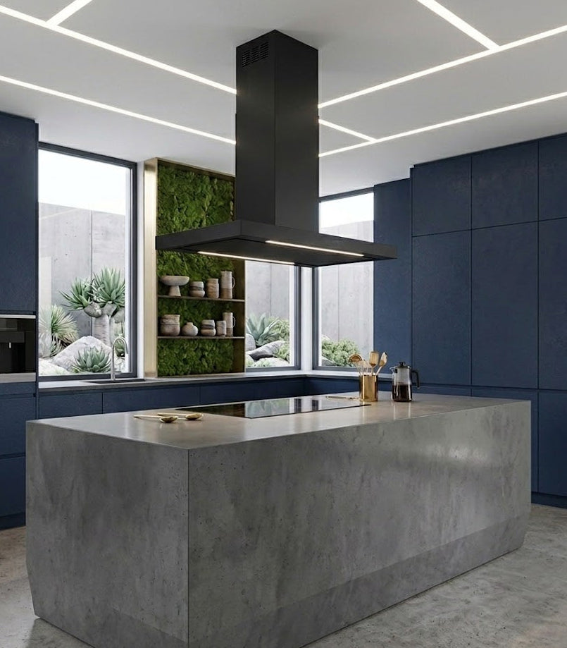 Black Lazio Island Cooker Hood Installed in a Modern Kitchen With a Concrete Island and Blue Cabinets