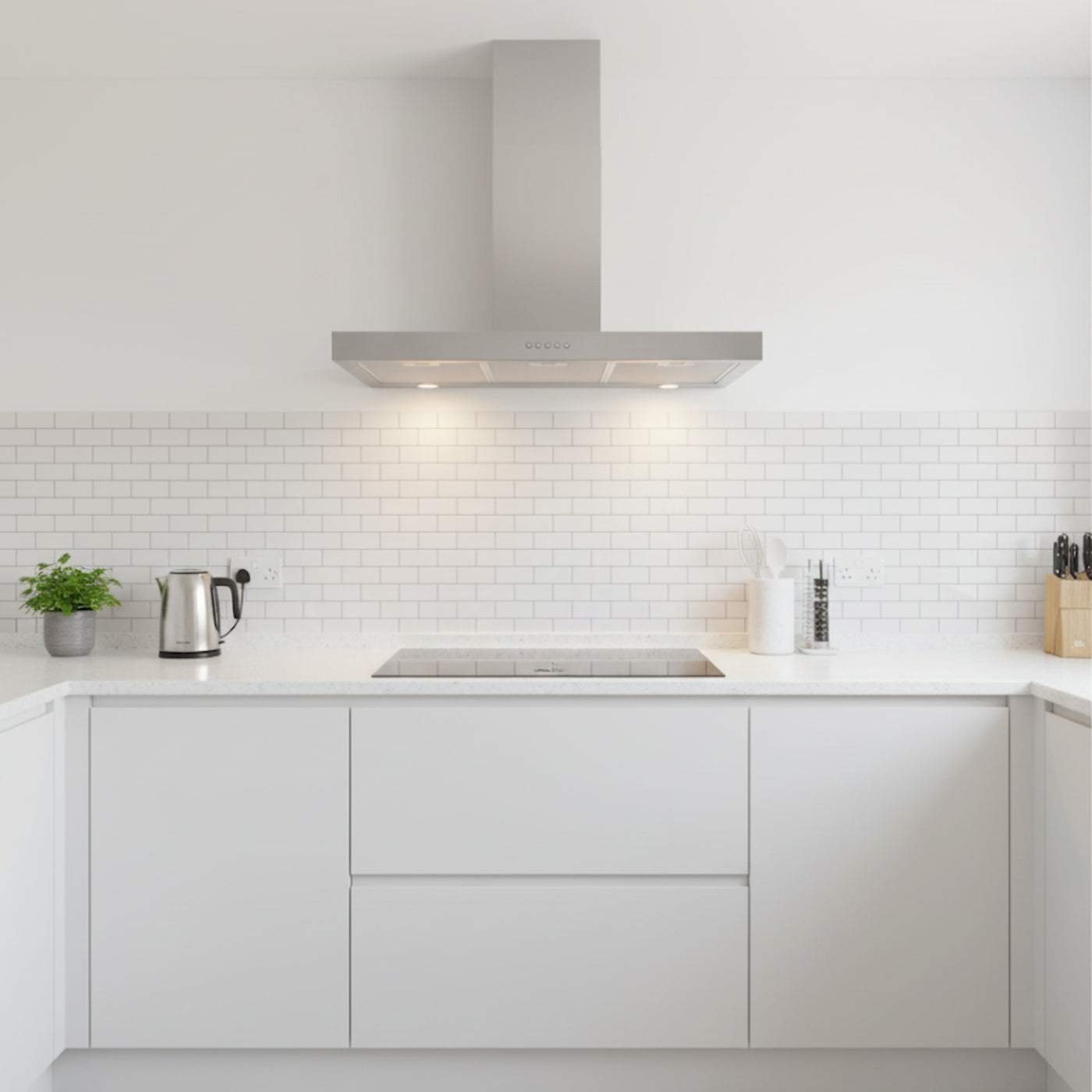 Stainless Steel FLT wall mounted cooker hood installed within a sleek, white, minimalistic kitchen