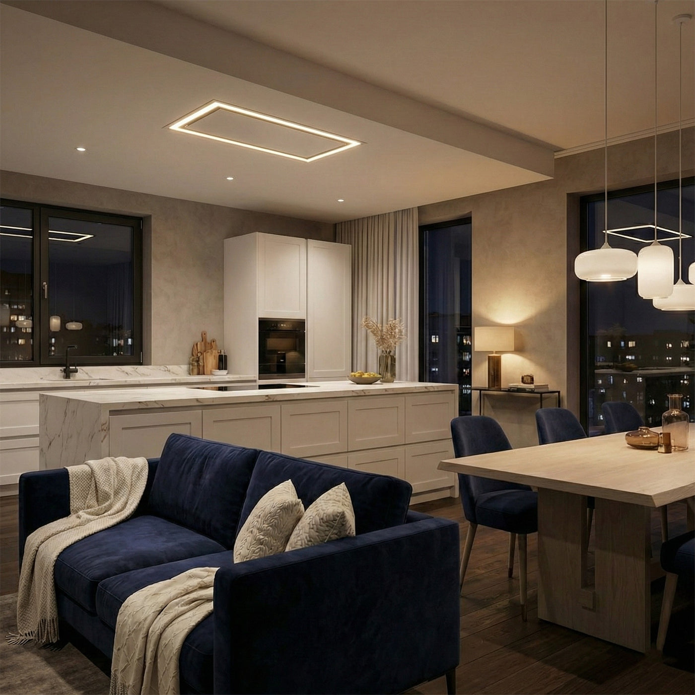 90cm White Caporra Ceiling Cooker Hood Installed in a Modern kitchen and dining area with a blue sofa and pendant lights.