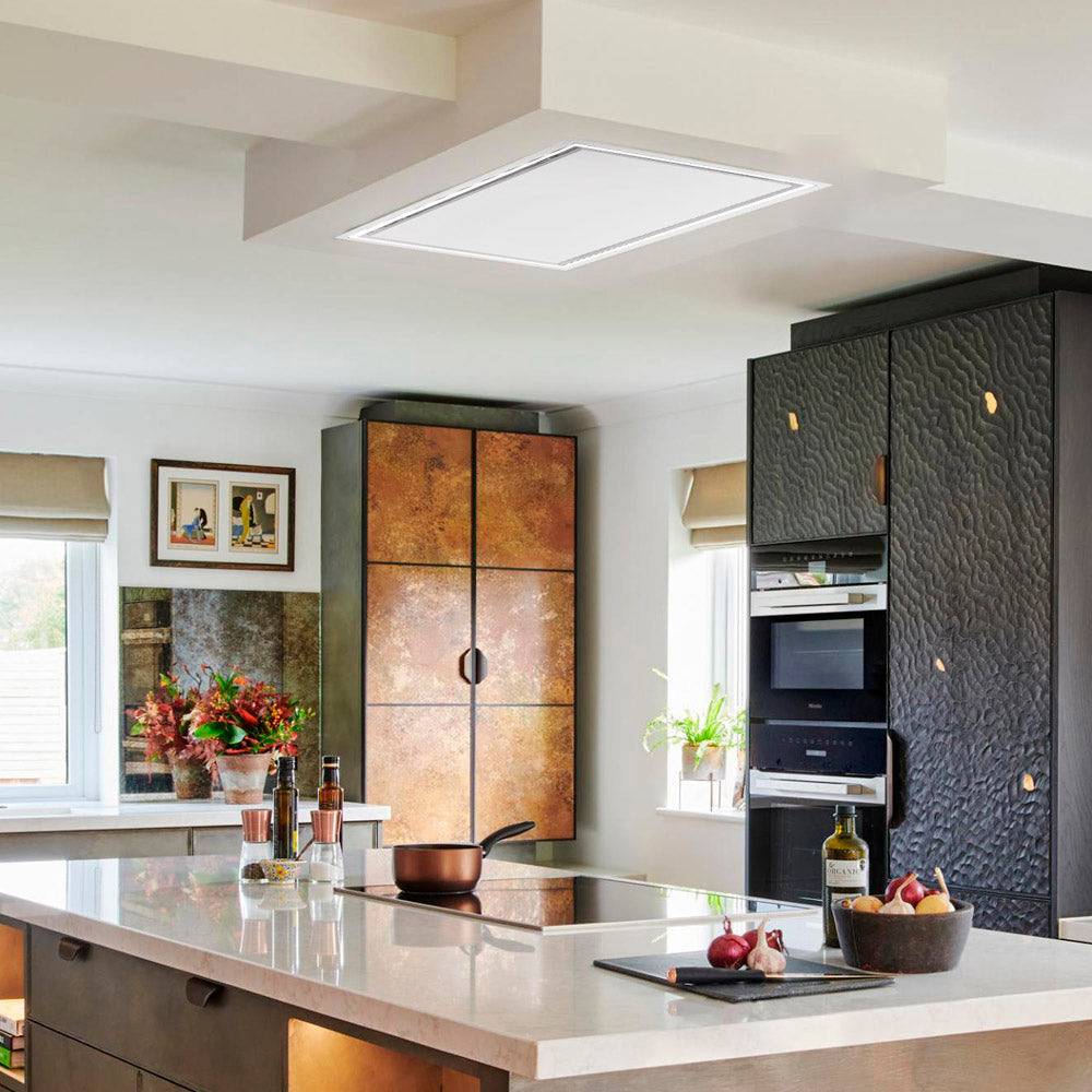 90cm x 50cm White Caporra Ceiling Cooker Hood Installed in a Modern kitchen with black and bronze cabinets, white countertops, and decorative elements.